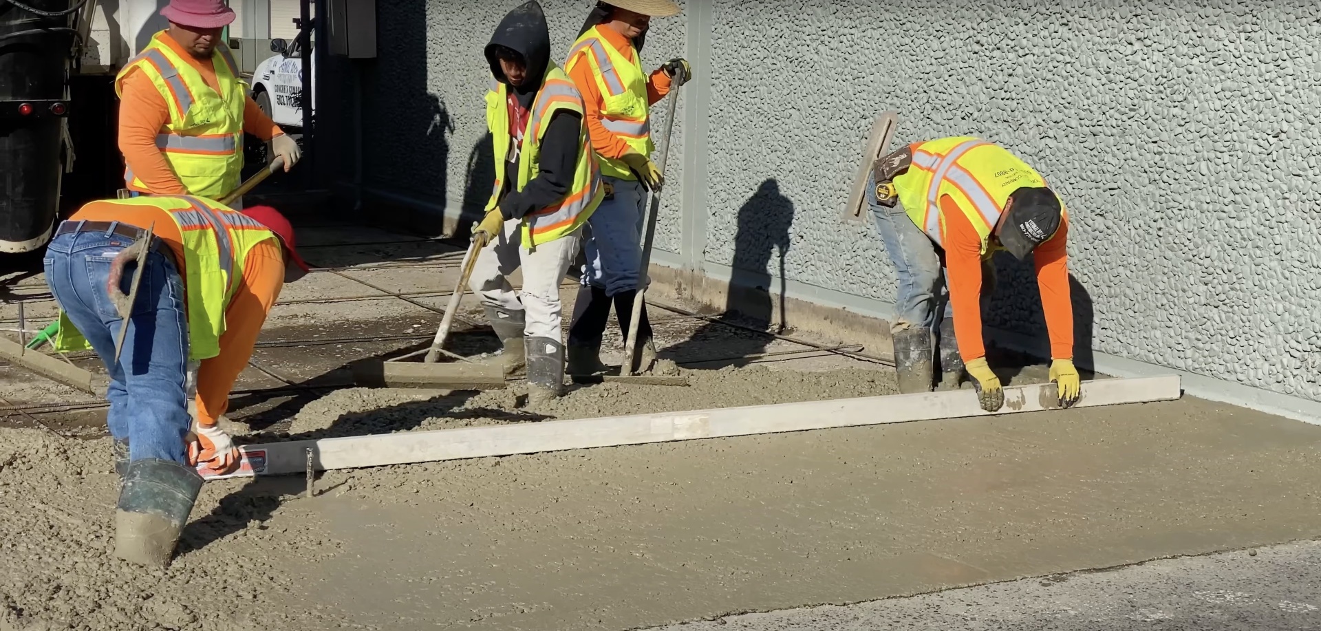 Professional concrete crew working on commercial project with proper safety equipment